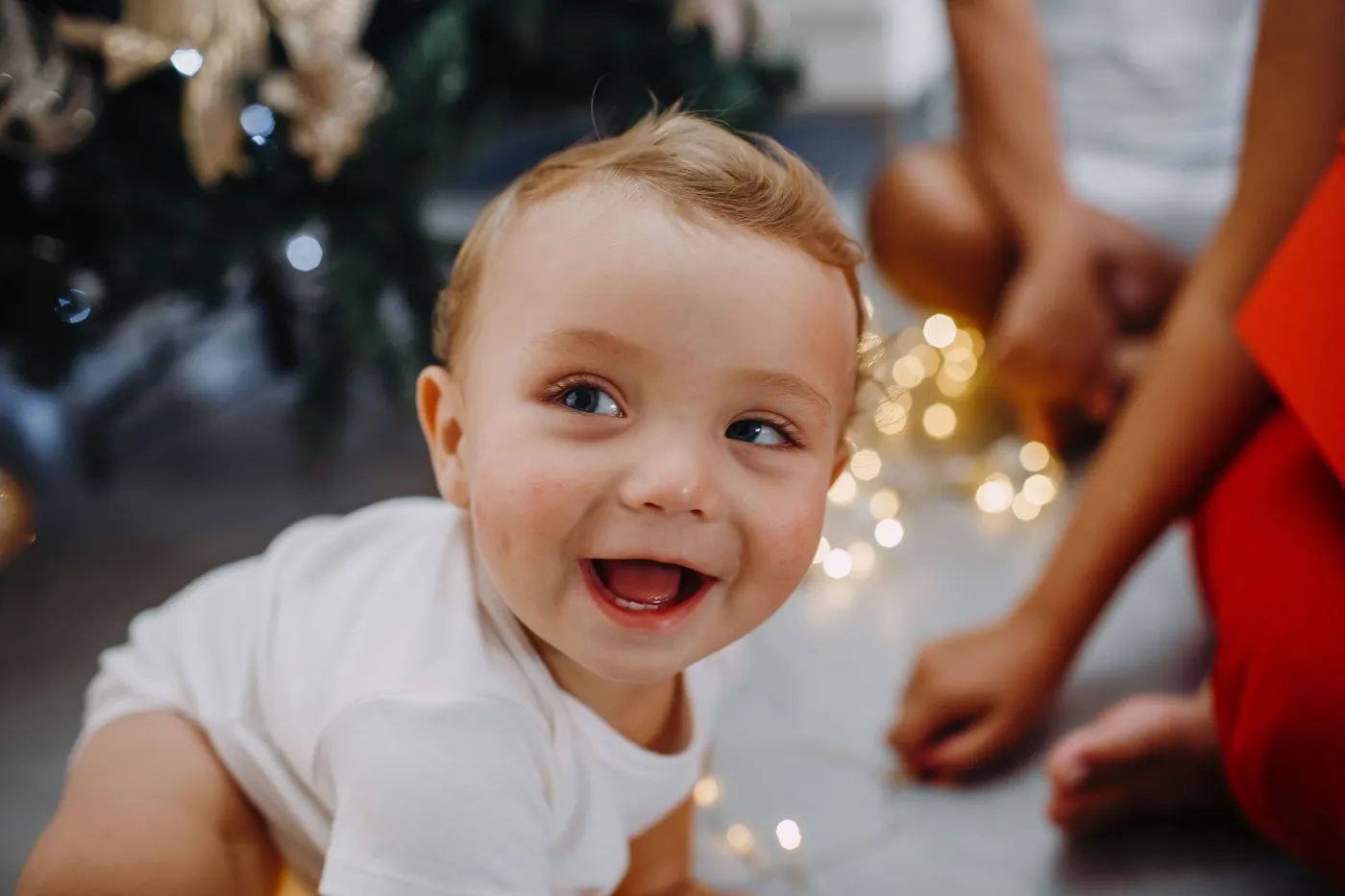 A toddler laughing at the camera